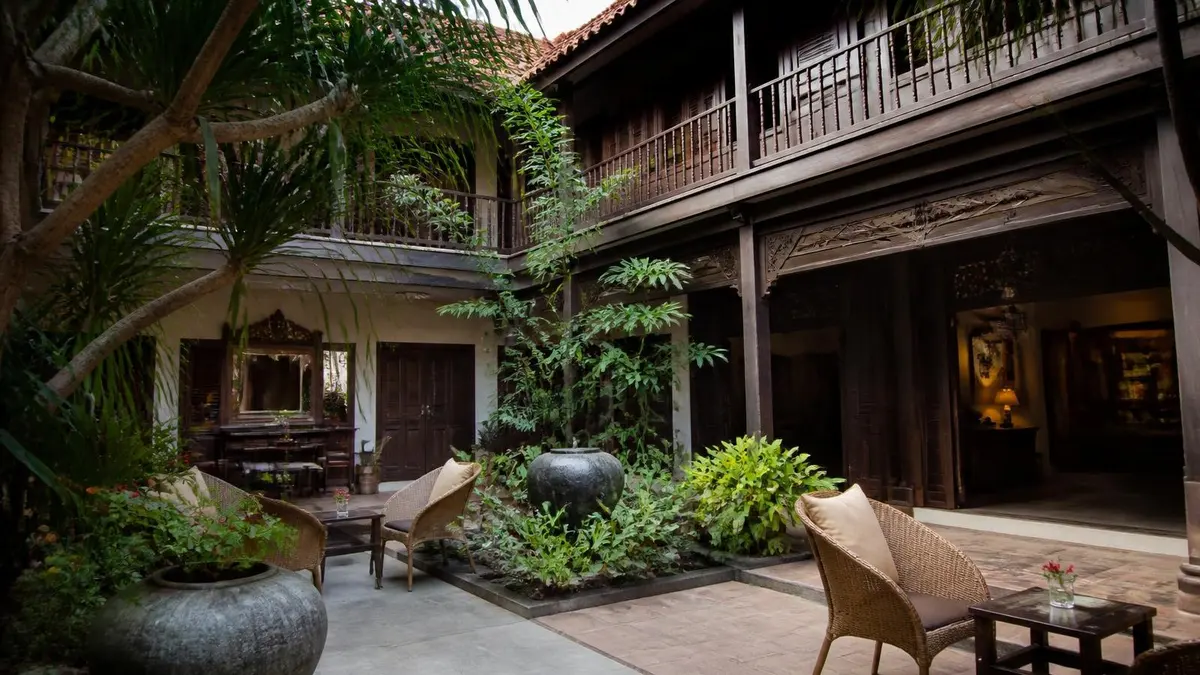 Courtyard of a teak heritage boutique hotel in Southeast Asia