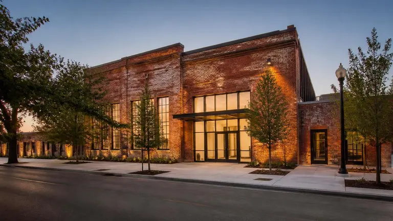 Renovated brick arts centre building at dusk in Texas