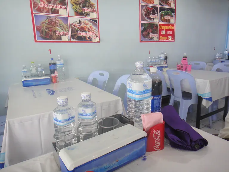 Small Bangkok Restaurant - Drinks, Cutlery Containers, Menus on Walls, Spices & Tissues