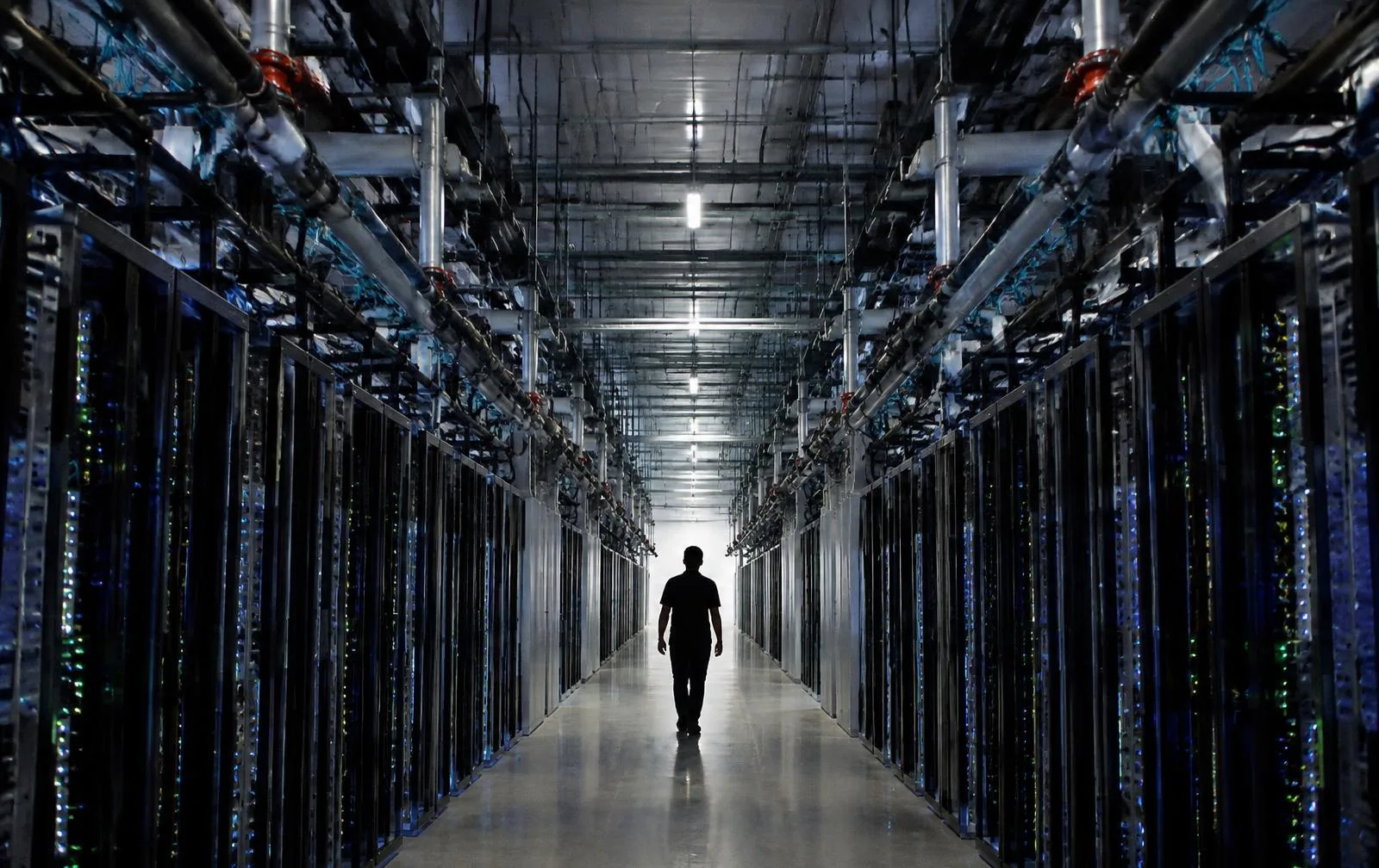 A long aisle of server racks inside a data centre