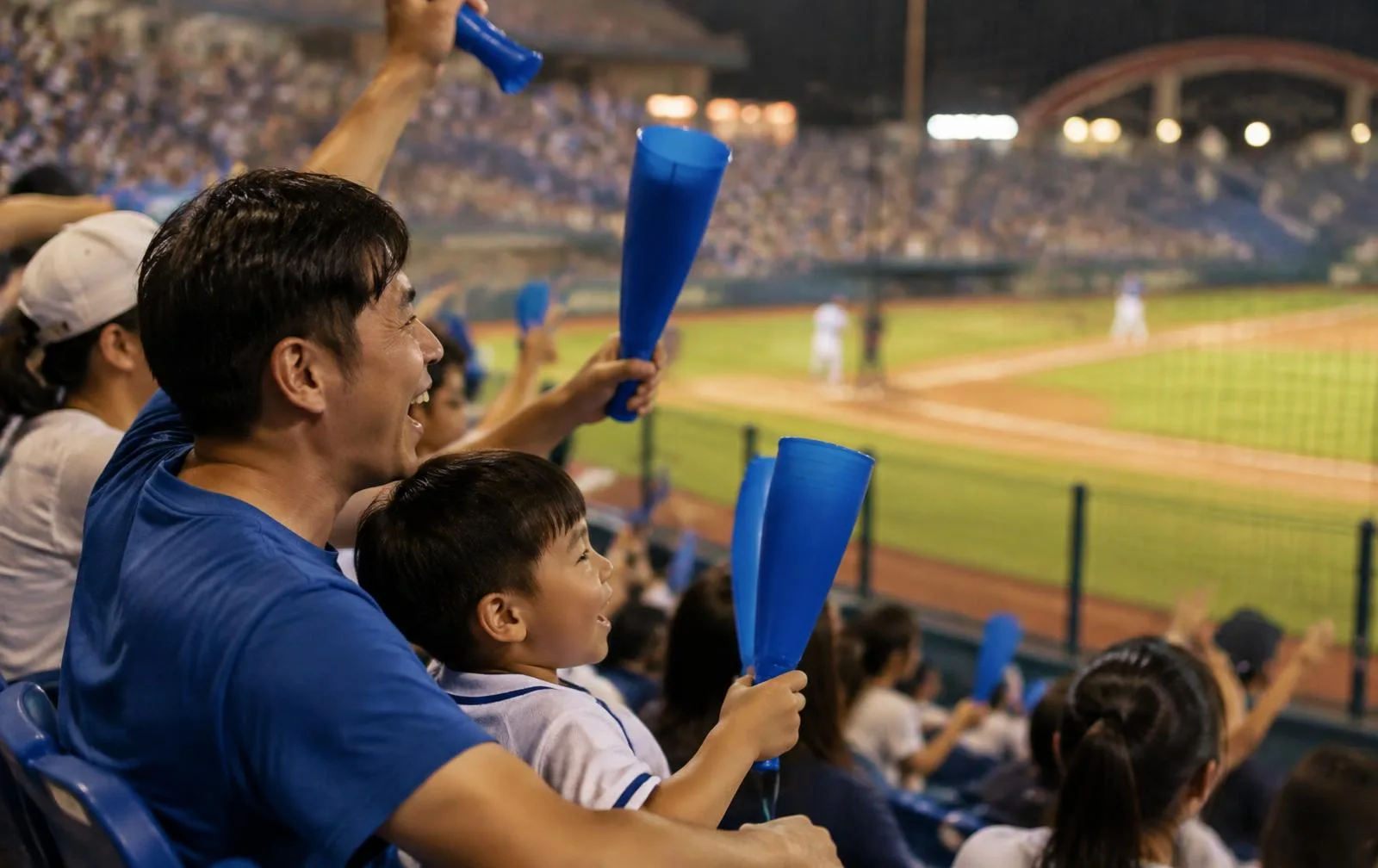 A father and son cheering close to the field