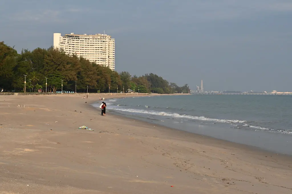 DSC_9603: a person standing on a beach next to the ocean