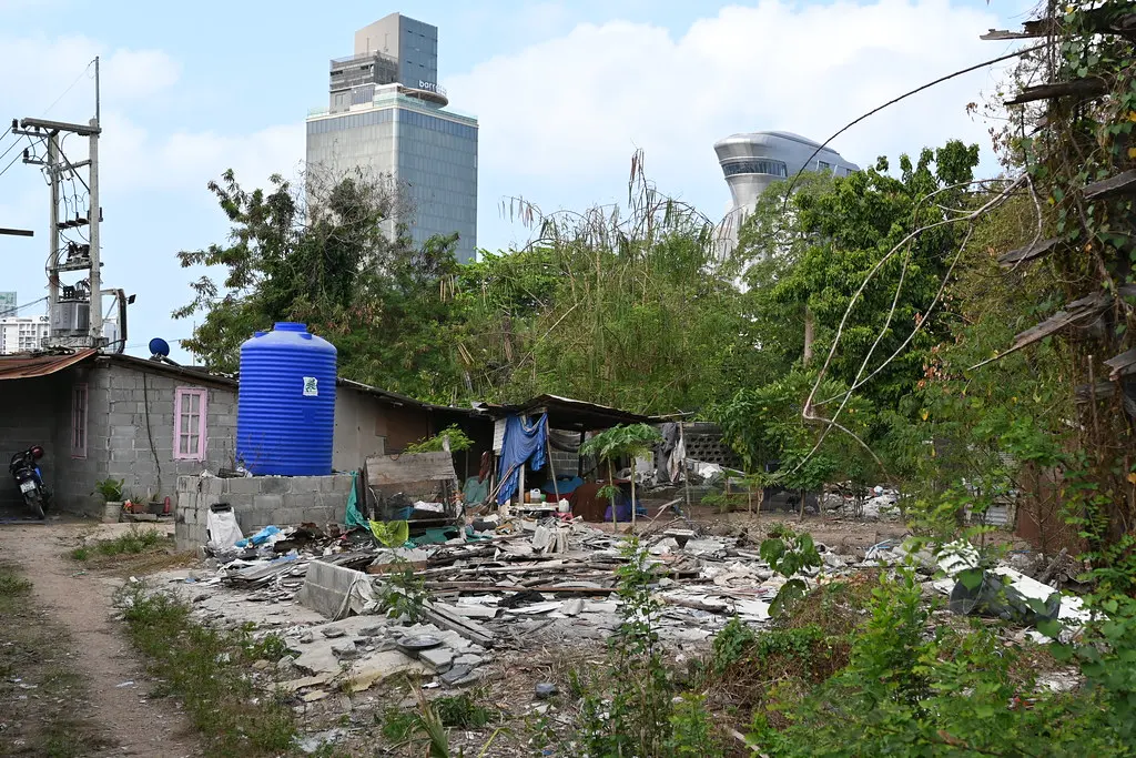 DSC_9755: a run down building with a lot of trash in front of it